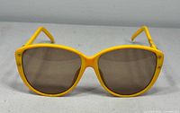 Front view of yellow Christian Dior sunglasses showing frame shape and lens tint