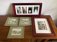 Overview of five framed artworks on table