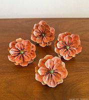 Top view of four peach flower napkin rings