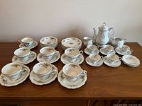 Both Bavarian sets and Clarence cup & saucer arranged on table