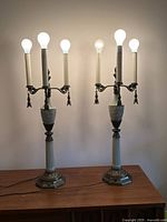 Both celadon lamps illuminated showing 4 bulbs each