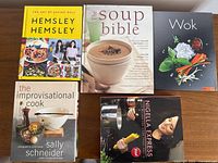 Front covers of all five cookbooks displayed on table