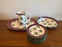 Overall shot of 11-piece set showing platter, pitcher, bowl and stacked plates