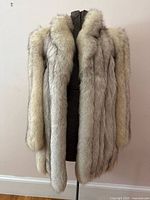 Front view of fur coat on dress form