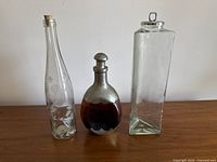 Front view of all three bottles showing size and shape differences