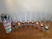 Full set of eight pool-ball pilsner glasses and cocktail shaker displayed on table