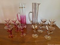 Both pitchers with twelve martini glasses displayed on table