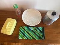 Group shot showing milk bottle, cake plate, Hall casserole dish, single Steel Masters canister and folded Irish towel