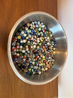 Overhead view showing full quantity of marbles in steel bowl