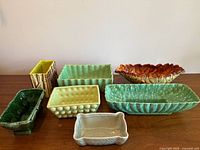 All seven ceramic planters arranged on table