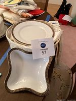 Stack of dinner plates in cloth storage case with relish dish on top