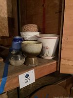 Group of assorted planters on shelf