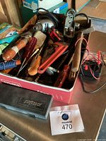 Overview of box with assorted hand tools and Portasol case