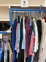 Full rack of assorted women’s garments on hangers
