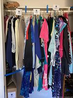 Full closet rod with assorted women’s garments on hangers