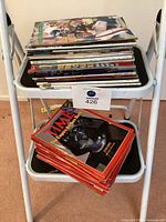 Full stack of magazines on stepladder – lower step shows multiple Time issues, upper step mixed titles