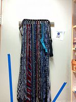 Full view of ties, bow tie and suspenders hanging