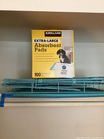 Front view of Kirkland absorbent pads box on shelf