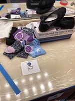 Overview of shoes boxes, socks packs and loose socks on countertop