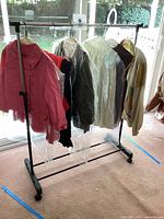 Full view of clothing rack with six hanging vintage garments
