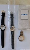 Group shot of all four watches: Energizer, City Rock Cafe, Superior, and boxed Casio
