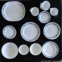 Overview of assorted Corelle Old Town Blue pieces laid out