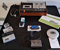 All items laid out: cassette deck, portable devices, accessories, manuals