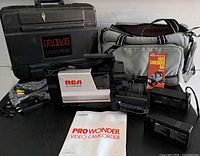 Entire lot showing camcorder, hard case, soft bag, battery, charger, cables, manual