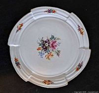 Front view of porcelain cake plate showing floral design and rim details