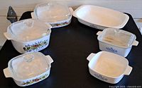 All ten Corning Ware pieces laid out showing both patterns and lids