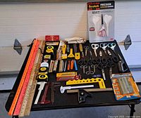 Overall lot on table showing scissors, rulers, calipers, tapes, square, knives