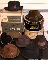 Front view of hats stacked on hat boxes