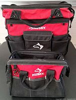 Both Husky tool bags front view showing size difference and external pockets