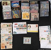 Overall lot with CDs in two rows, envelopes stacked, railway stamp pane visible