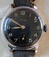 Close view of Kienzle watch dial showing brand name, numerals, hands, subsidiary seconds