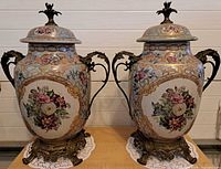 Front view of both matching lidded urn vases showing size and design