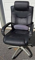 Front view of black vinyl swivel office chair with grey lumbar cushion