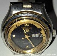 Front view of Seiko 5 watch showing dial, bezel and scratches on crystal