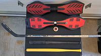 Overview of all items: two RipStiks, spare wheel, hockey stick, two bats