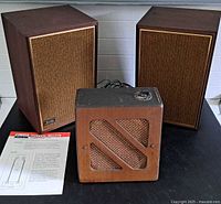 Front view showing pair of Wharfedale W25 speakers, vintage speaker, and technical bulletin
