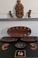 Group shot of all ten carved wooden items displayed