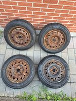 All four tires and rims laid out, showing overall condition