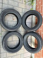 Four tires arranged in square on pavement