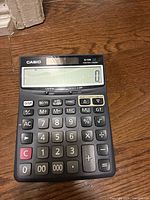 Front view showing Casio branding, 12-digit LCD display and key layout