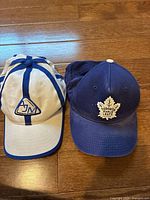 Front view of both hats showing logos and colors