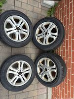 All four Mercedes-Benz alloy rims with mounted Kinforest tires displayed on pavement