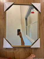 Front view of mirror with protective corner covers attached