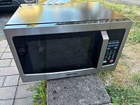 Front view of Toshiba stainless microwave showing door and control panel
