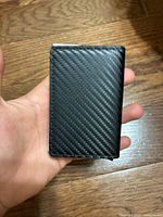 Front view of black carbon-fiber pattern card holder wallet