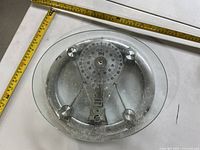 Top view of glass oval analog bathroom scale with measuring tape for size reference